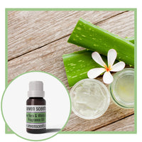 Aloe vera and white lily fragrane oil with aloe vera and a flower on a wooden surface