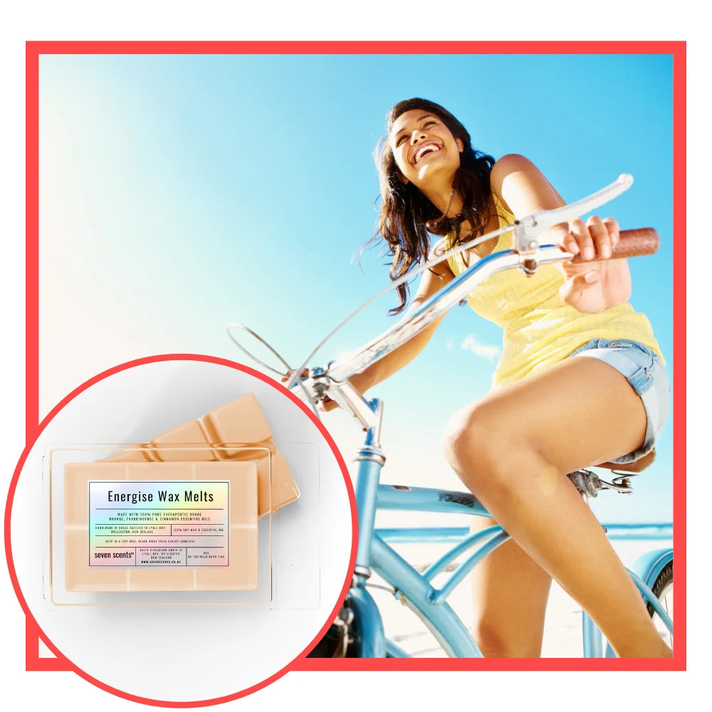 Woman on a bicycle with a close-up of energise wax melts packaging.