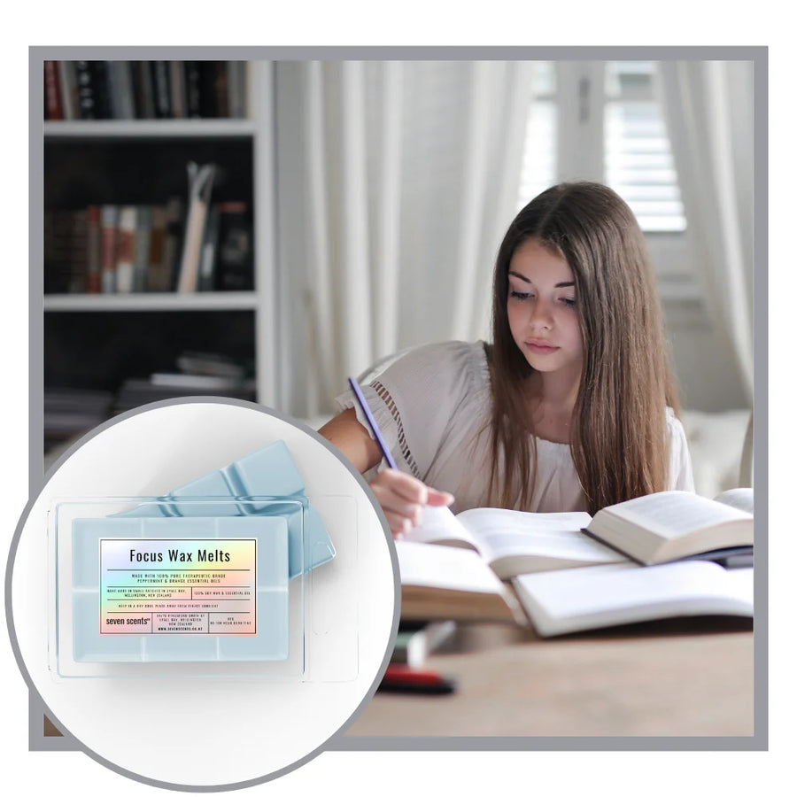 Woman studying with a package of Focus Wax Melts in the foreground