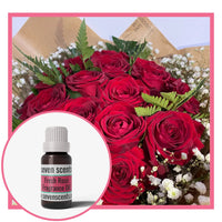Fresh rose fragrance oil with a bouquet of fresh red roses