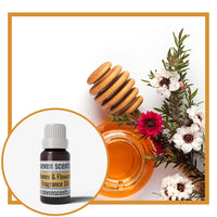 Honey and flower fragrance oil with honey and flowers on a light background.