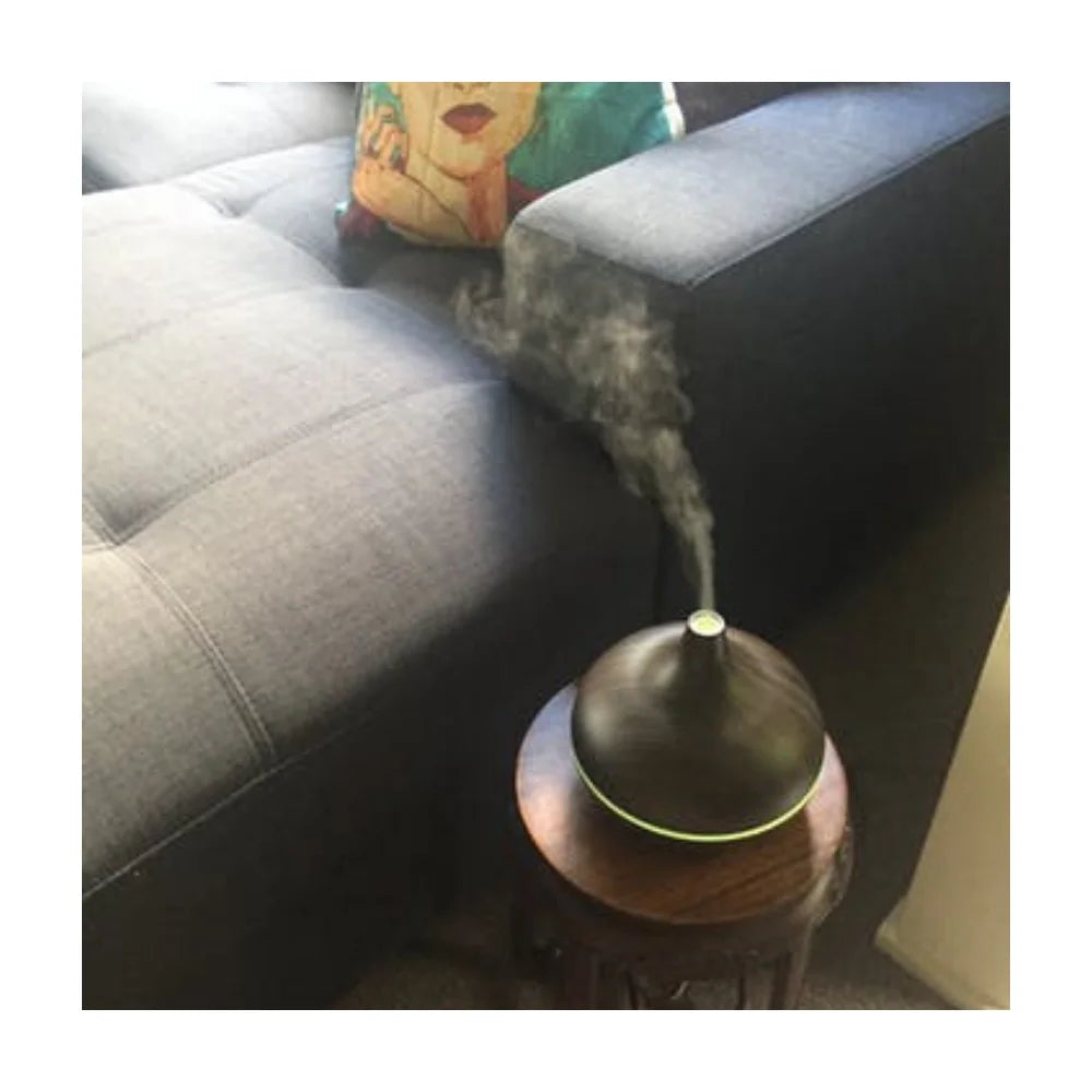 Lucy oil diffuser in dark wood creating warm atmosphere in home office