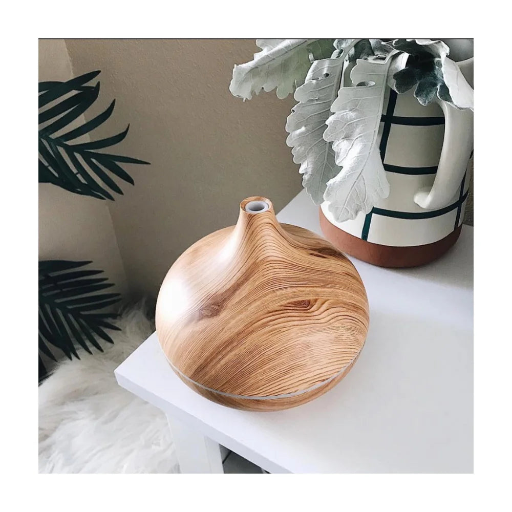 Lucy aroma diffuser with natural wood aesthetic on bedside table at night