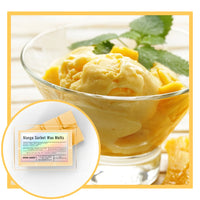 Mango sorbet ice cream in a glass bowl with mango slices and leaves, accompanied by Mango Sorbet Wax Melts packaging.