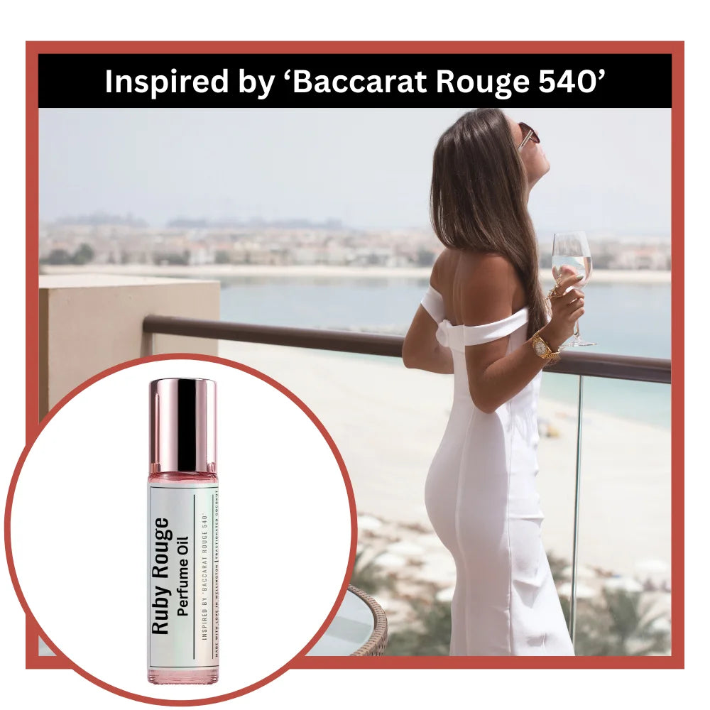 Ruby rouge perfume oil inspired by Baccarat Rouge 540 with a women on a balcony with a glass of wine