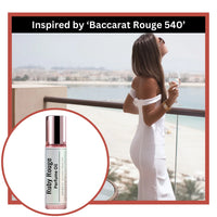 Ruby rouge perfume oil inspired by Baccarat Rouge 540 with a women on a balcony with a glass of wine