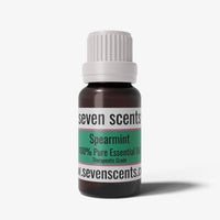 Spearmint essential oil bottle by Seven Scents with a white cap on a white background