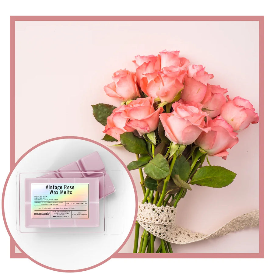 Bouquet of pink roses with a box of 'Vintage Rose Wax Melts' on a light pink background